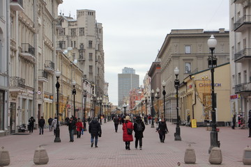 Fototapeta premium Walking people on Moscow pedestrian street Old Arbat on a winter day