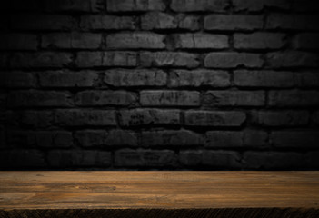 Selected focus empty brown wooden table and wall texture or old black brick wall blur background image. for your photomontage or product display