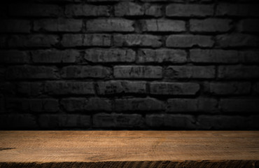 Selected focus empty brown wooden table and wall texture or old black brick wall blur background image. for your photomontage or product display