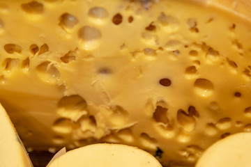 Different sort of cheeses on a wooden board for sale