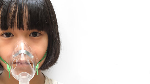 Asthma Breathing In Children Problem Concept. Asia Pediatric Patient Kid Girl With Inhaler Sick With Bronchitis Isolated On White Background With Copyspace.