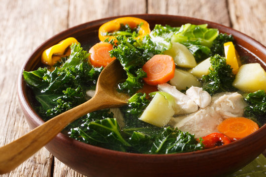 Rustic Style Chicken Soup With Kale And Vegetables Close-up In A Bowl. Horizontal