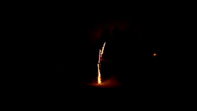 Launch a festive firework, rocket launcher fireworks start from the ground and explode in the dark night sky, stock video