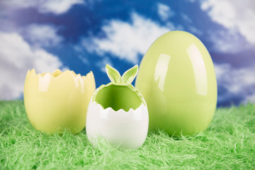 Easter, colorful eggs on green grass.