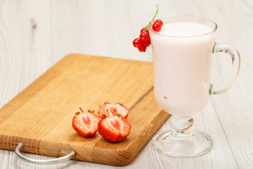 Delicious strawberry yogurt with mint leaves in glass.