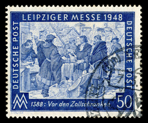 GERMANY - 7 march 1948:  German historical stamp: spring Leipzig Trade Fair with special cancellation, 7 March 1948, medieval merchants trade in the market of the city, East Germany