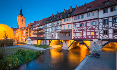 Historic city center of Erfurt with famous Krämerbrücke bridge illuminated at twilight,...