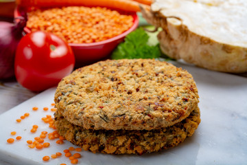 Tasty vegetarian food, raw burgers made from lentils legumes with vegetables ready for cooking