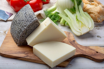 Italian cheeses, mature Tuscan Pecorino sheep cheese and Provolone dolce cow cheese served with olive bread and tomatoes