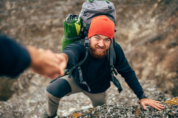 Horizontal outdoors image of traveler bearded man trekking and mountaineering during his journey....
