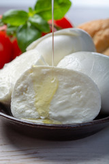 Balls and pieces of buffalo mozzarella, soft Italian scheese made from the milk of Italian Mediterranean buffalo
