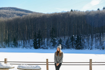 Beautiful blonde girl posing in snow