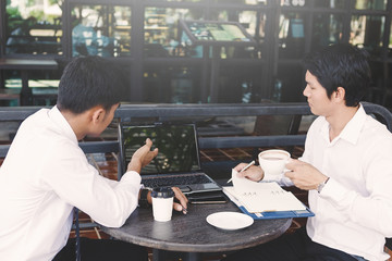 young businessman discussing about financial budget and improvement of start up business at lifestyle coffee shop