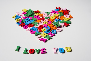 Alphabet letters on wooden square pieces forming heart shape