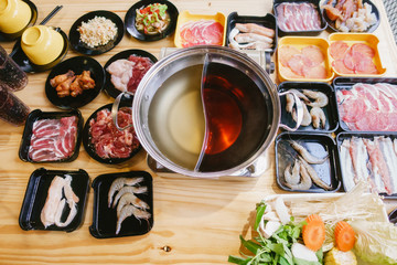Sukiyaki set,pork,beef,vegetable on  wooden table background.