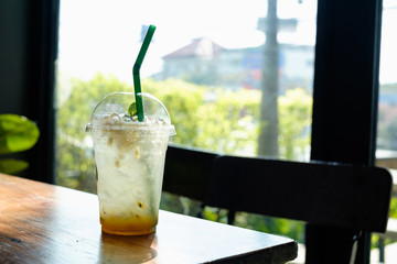 Fresh passion fruit juice and haft passion fruit on top with wooden table background. Hipster style.