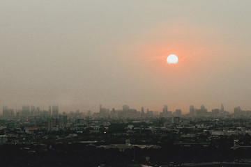 The fog and cloud covering the sun over the city.