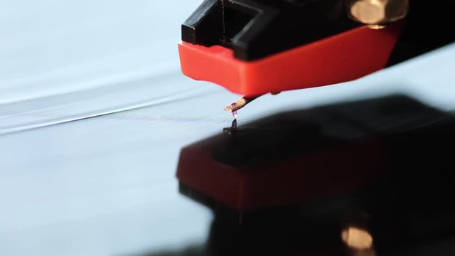 macro footage of vintage playing turntable with focus on stylus