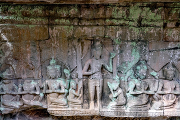 Detail of Ancient temple name Bayon Angkor with stone faces Siem Reap, Cambodia. Bayon's most distinctive feature is the multitude of serene and smiling stone faces on the many towers 