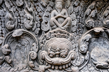 Detail of Ancient temple name Bayon Angkor with stone faces Siem Reap, Cambodia. Bayon's most distinctive feature is the multitude of serene and smiling stone faces on the many towers 