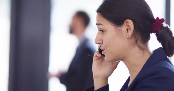 4K Angry young businesswoman in corporate office having an argument over phone