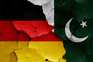 flags of Germany and Pakistan painted on cracked wall