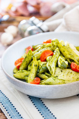 Pasta with pesto sauce and nuts on a the table