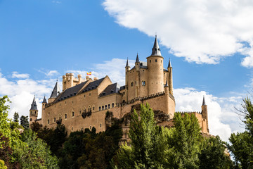 The famous view of the Alcazar of Segovia in a sunny summer day from the view point of la Pradera de San Marcos, Segovia, Castilla y Leon, Spain
