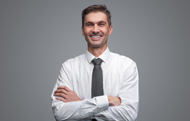 Confident businessman cheerfully smiling