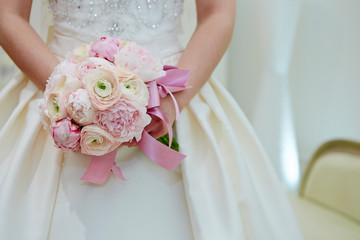 wedding bouquet in hands of bride