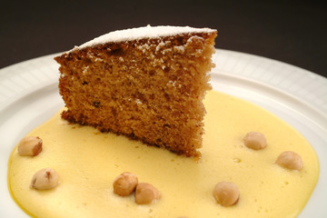 Italian food recipe, traditional hazelnuts cake and eggnog sauce