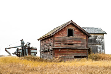 Fototapeta premium Abondoned farm buildings dot the landscape along HWY 4, Saskatchewan, Canada