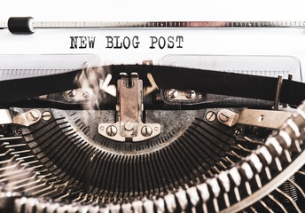 words NEW BLOG POST written on old manual typewriter