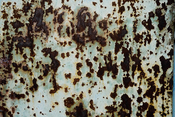 Iron wall with dark brown rust. Corroded metal. Background for design 