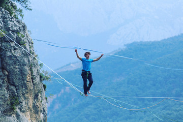 Man balancing on the rope concept of risk taking and challenge.