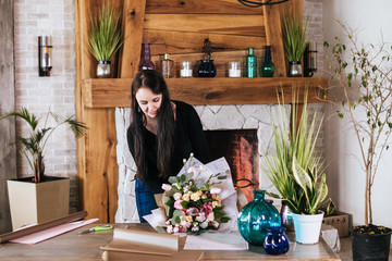 Side view of florist arranging bouquet while standing in flower shop