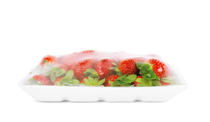 Fresh strawberries in a container on a white background