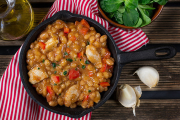 Chicken stew with navy beans and peppers in tomato sauce