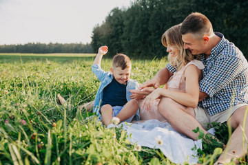 Fototapeta premium Parents and little son on vacation playing together