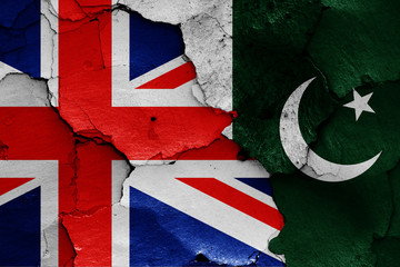 flags of UK and Pakistan painted on cracked wall