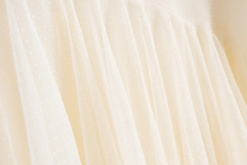 Beautiful handmade white wedding dress. Material closeup background with bokeh.