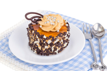 Caramel cake with butter cream and chocolate drops