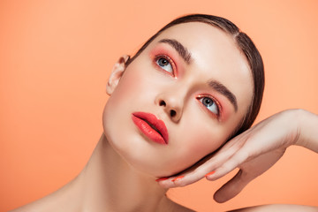 beautiful stylish young woman posing isolated on coral