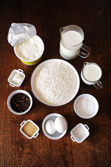 Ingredients for coffee cream cake on dark wooden background. Top veiw