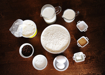 Ingredients for coffee cream cake on dark wooden background. Top veiw