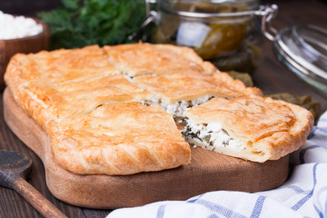 Homemade puff pie with pickled cucmbers and cottage cheese