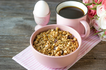 Healthy breakfast with granola, milk, honey and coffee, selective focus