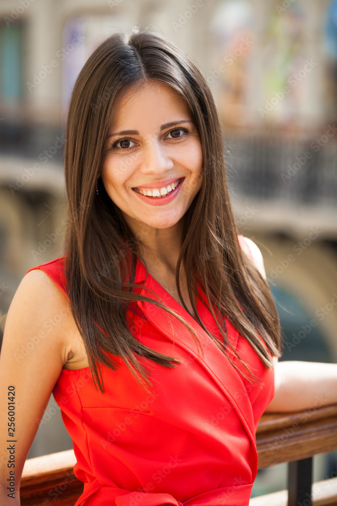 Canvas Prints Beautiful young brunette girl in a red dress