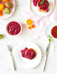 healthy breakfast with pancakes and cherry sauce.