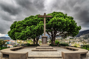 Beautiful ominous view of the monument cross on top of the Barcelos viewpoint (Miradouro Pico dos...